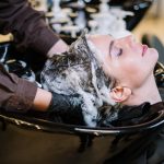 person washing woman s hair