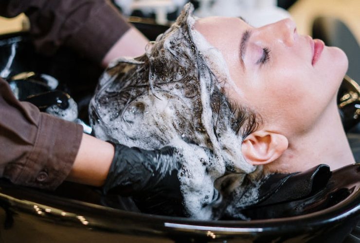 person washing woman s hair