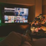 black flat screen tv turned on displaying man in black suit