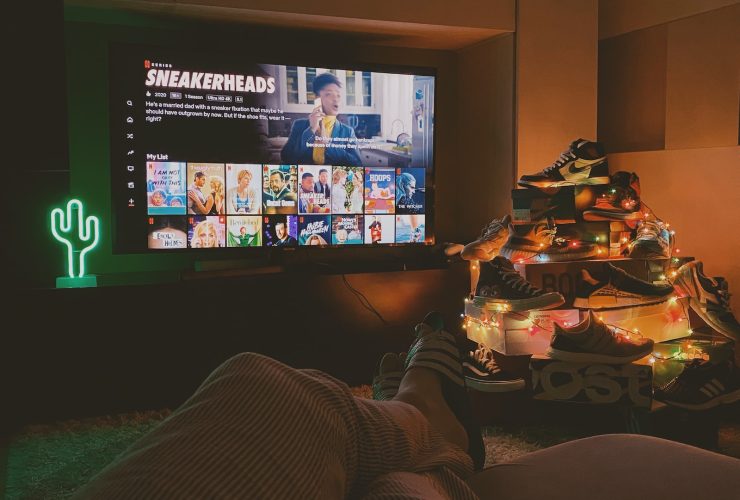 black flat screen tv turned on displaying man in black suit