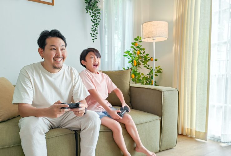 a person and a child sitting on a couch