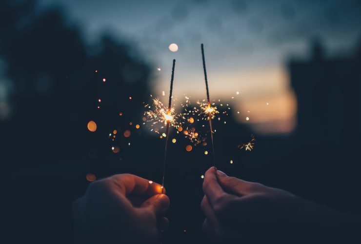 person holding fire cracker shallow focus photography