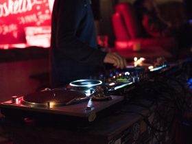 person using DJ controller while standing