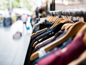 Vrouw die badpakken bekijkt aan een sale-rek in een modezaak