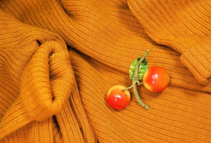Een vintage emailbroche vastgespeld op een donkere coltrui als winteraccessoire