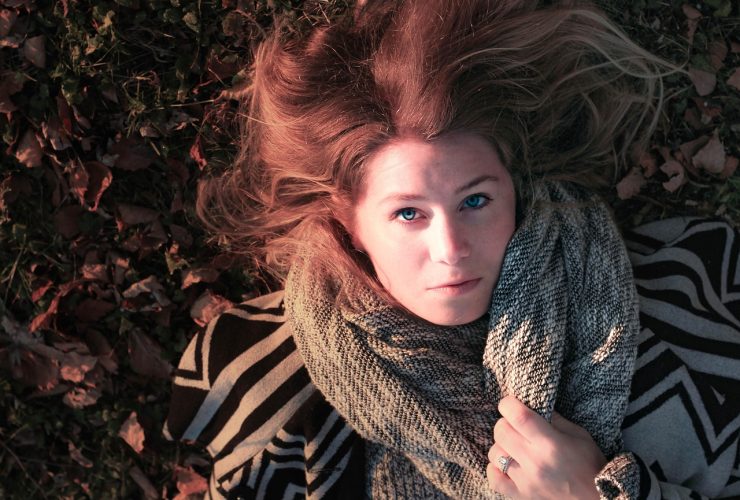 Vrouw met een elegant gedrapeerde sjaal in herfstkleuren