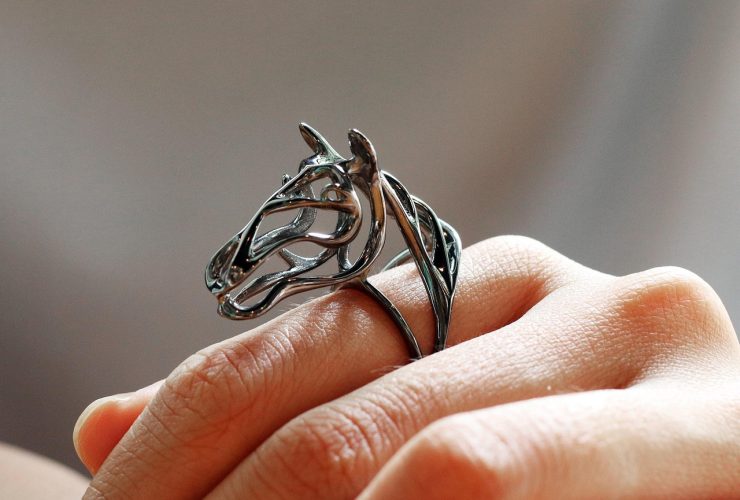 Een verzameling gouden en zilveren ringen uitgestald op een houten oppervlak, klaar voor groothandel inkoop
